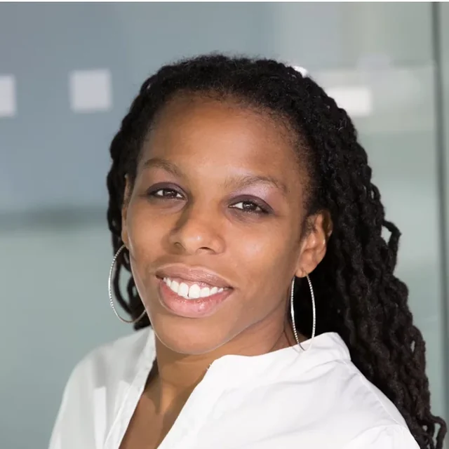Smiling au pair in a white blouse in a bright, uncluttered indoor setting